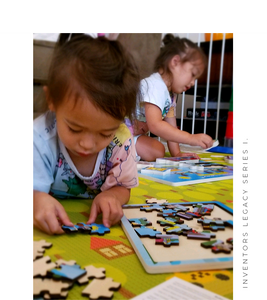 Child playing with Inventors Legacy Series 1 48 piece wooden jigsaw puzzle.
